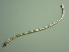 A NINE CARAT GOLD CHANEL SET DIAMOND BAR LINK BRACELET having sixteen links each with six tiny