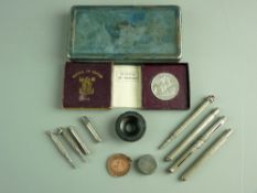 A WWI CADBURY BOURNVILLE CHRISTMAS TIN and contents including a quantity of white metal pens,