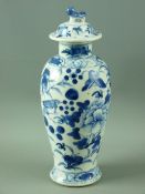 A 19th CENTURY CHINESE BLUE & WHITE LIDDED VASE decorated with birds amongst fruit and flowers,