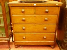 A VICTORIAN MAHOGANY CHEST of two short over three long drawers with turned wooden knobs, raised