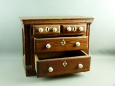 A PITCH PINE APPRENTICE CHEST having two short over two long drawers with bone escutcheons and