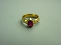 AN EIGHTEEN CARAT GOLD PINK TOURMALINE SOLITAIRE DRESS RING, the oval faceted tourmaline flanked