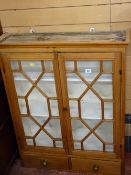 AN ANTIQUE STRIPPED PINE WALL CUPBOARD having twin thirteen pane astragal glazed doors above a