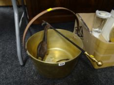 A large brass preserve pan, brass handled poker & a cast metal novelty goose doorstop etc