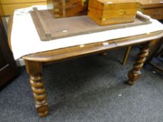 A vintage oak extending dining table with barley-twist legs