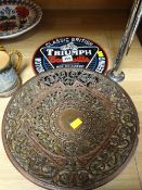 A pierced metal & classically decorated wall plaque together with a metal Triumph Bonneville