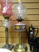 A brass Corinthian column based floral painted reservoir & clear glass shade oil lamp