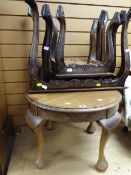 A nest of three carved wood tables together with a circular small coffee table