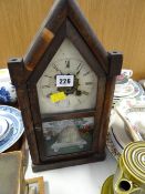 A vintage American architectural mantel clock with painted beehive style door