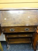 A vintage narrow oak bureau with bookshelf base