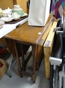 A vintage oak drop leaf occasional table