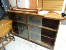 A vintage double glass sliding door low bookcase together with a Gordon Russell Long John coffee ta