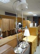 Two modern brushed stainless steel standard lamps together with a similar table lamp