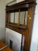 Early nineteenth century mahogany fireplace surround with mirrored top and convex shelving with a
