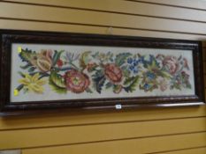 A carved mahogany framed tapestry / embroidery of flowers dated 1946