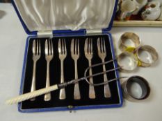 Set of six hallmarked silver cake forks, four various hallmarked napkin rings together with a silver