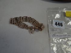 An 9ct gate bracelet with 9ct gold heart padlock