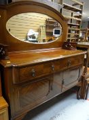 A reproduction mahogany mirror backed sideboard, two drawers above two cupboards on raised feet