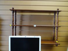 A mahogany three-tier hanging wall shelf
