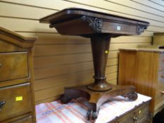 An antique mahogany foldover card table with central column support and splayed feet