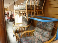 A three-piece bamboo and cushioned conservatory suite together with a matching glass topped coffee