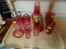 A collection of good quality cranberry glass, dressing table items, sugar sifter etc