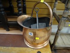 A copper coal scuttle