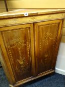 An ornately decorated mahogany banded standing corner cupboard