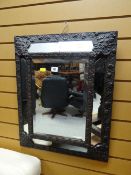 A vintage flower decorated metal framed wall mirror