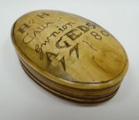A HORN SNUFF BOX of oval form with sgraffito writing to the hinged lid as follows 'HH CAUA Gwnion