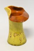 AN EWENNY POTTERY GREEN GLAZED VASE / JUG inscribed 'Y Gwir yn Erbyn y Byd', impressed marks 'JONES'