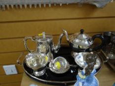 A three-piece EPNS tea service on a glass & chrome oval tray etc