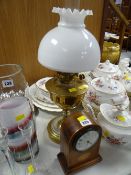 An inlaid Edwardian mantel clock & a brass based oil lamp