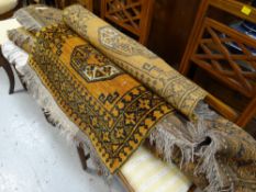 A parcel of three various sized but similar patterned gold & black Iranian woollen rugs