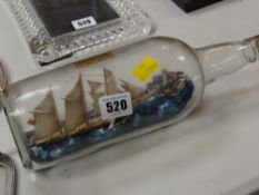 Vintage ship in bottle with inscription to the base outlining the ship