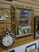 A gilt framed mirror & a gilt framed fancy clock
