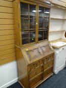 A reproduction Jacobean-style light oak bureau bookcase