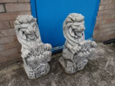 A pair of stone heraldic lion gate post tops (outside)