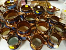 A collection of copper lustre jugs