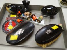 A pair of gentleman's clothes brushes with silver monograms, two car grill badges etc