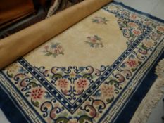 A large Chinese washed woollen rug in blue & cream