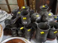 A quantity of pewter items including a shot flask, a court jug etc