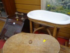 A vintage kidney shaped pottery wash basin on a bentwood stand together with an antique pedonium