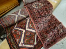 Two Iranian wool runners, red & cream patterned and the other pink