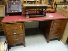 A vintage wooden office desk with two banks of two drawers