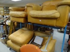 A brown leather three-seater settee & matching armchair with pouffe (possibly from Maples of Totte