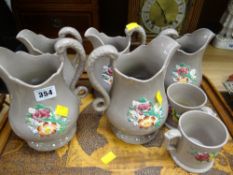 A set of floral pottery jugs & tankards