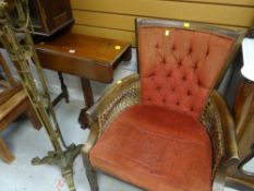A vintage cane work & upholstered armchair together with a drop-flap occasional table