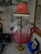 A vintage brass standard lamp on hexagonal stand with shade