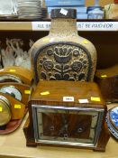 A 1930s polished mantel clock & a stoneware vase